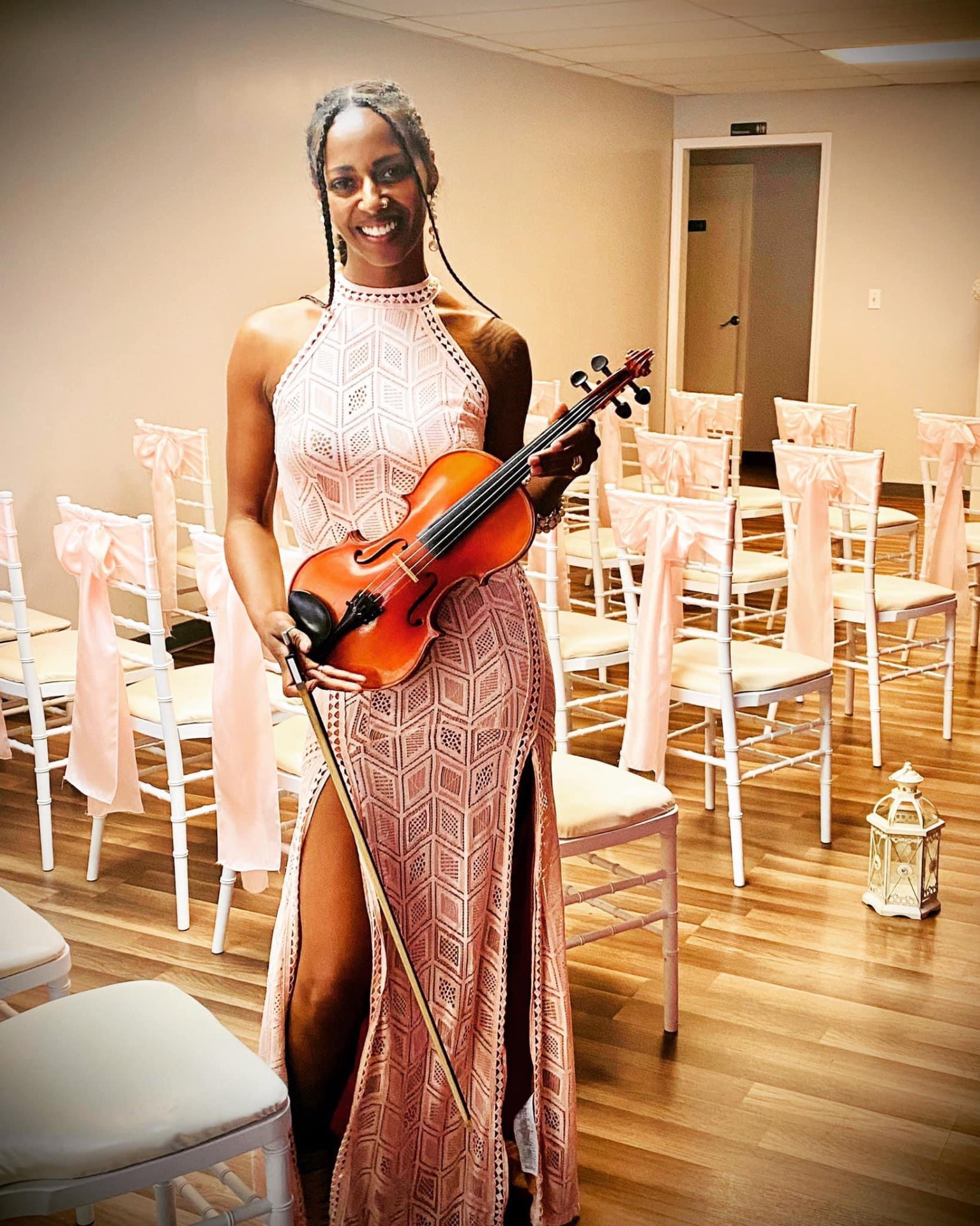 Katrina Grantham holding her violin before a ceremony